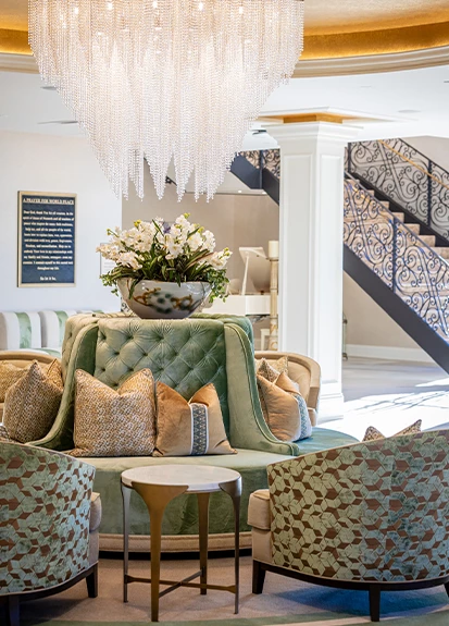 a room with a couch and chairs