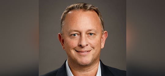 a man in a suit smiling