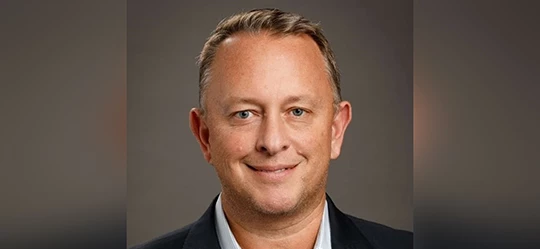 a man in a suit smiling