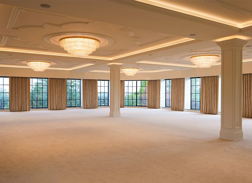 a large room with chandeliers and windows