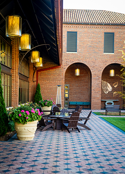 a patio with chairs and a table