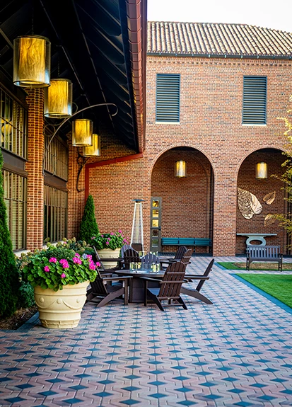 a patio with chairs and a table