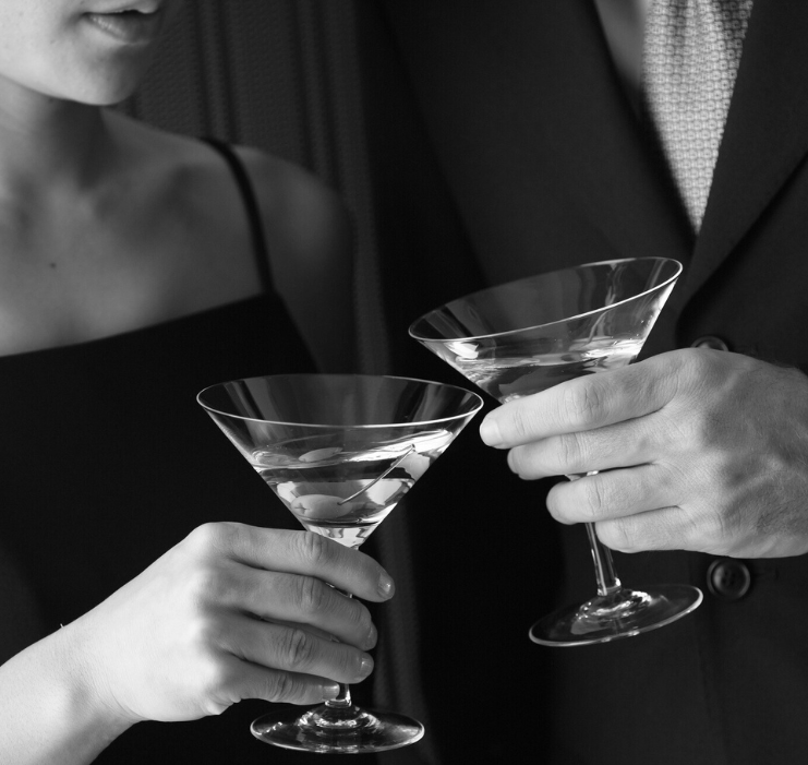 a man and woman holding martini glasses