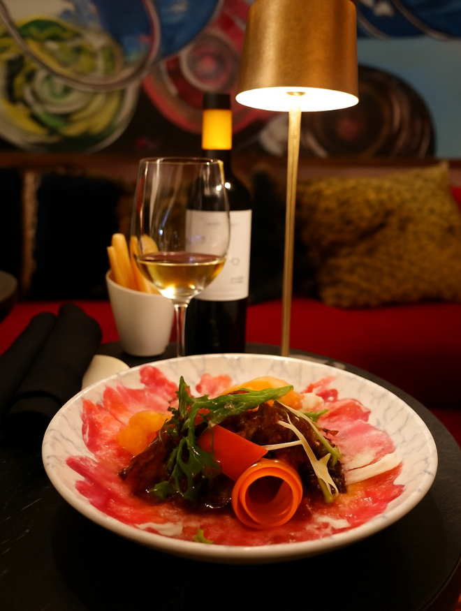 a plate of food and a glass of wine