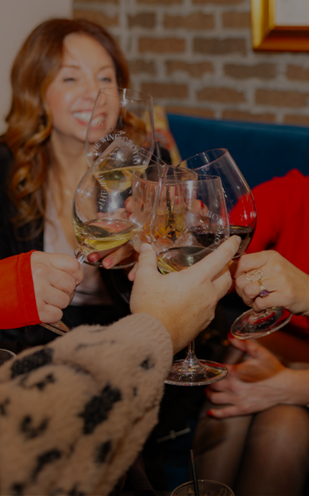 a group of people holding wine glasses