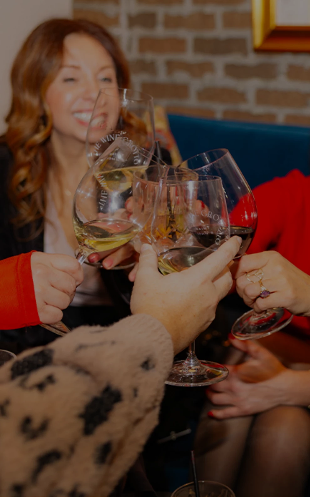 a group of people holding wine glasses