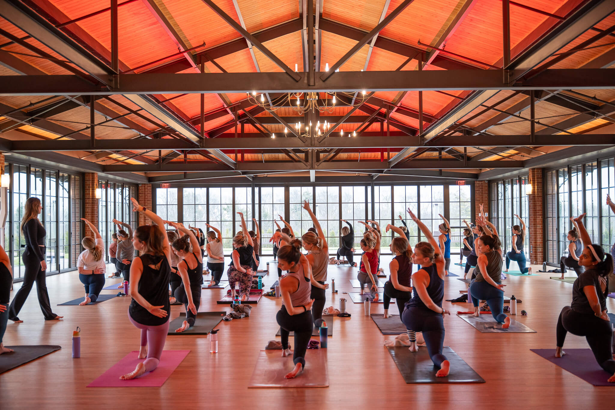 a group of people in a room with yoga mats