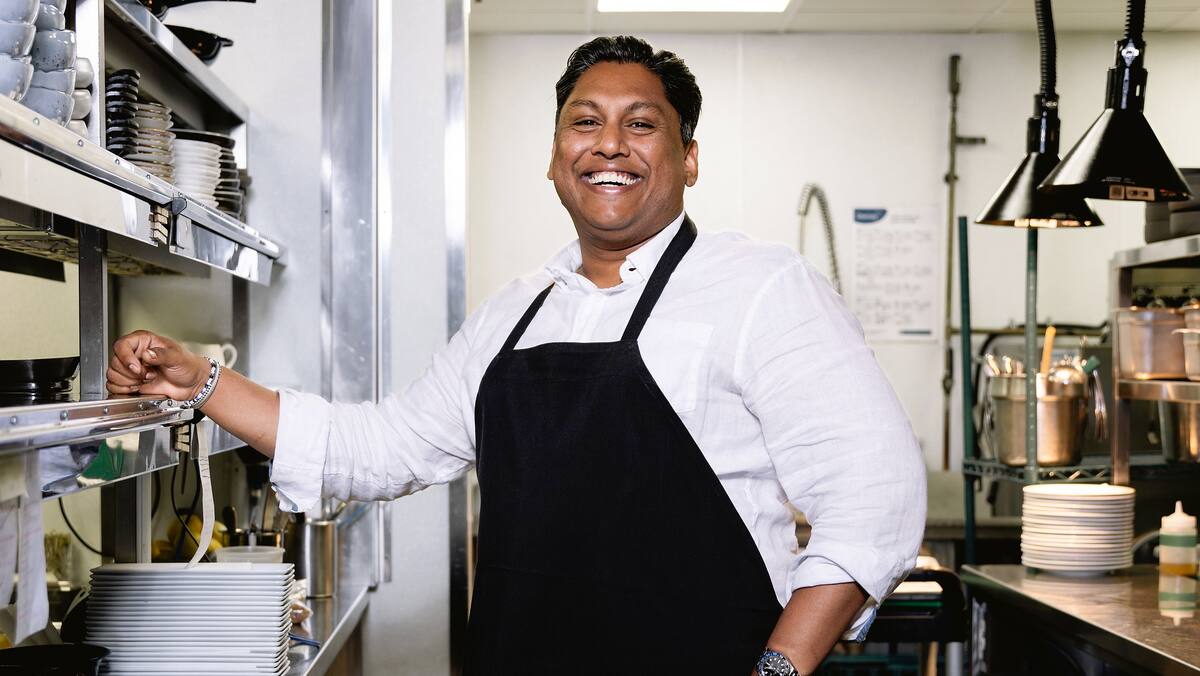 a man wearing a black apron