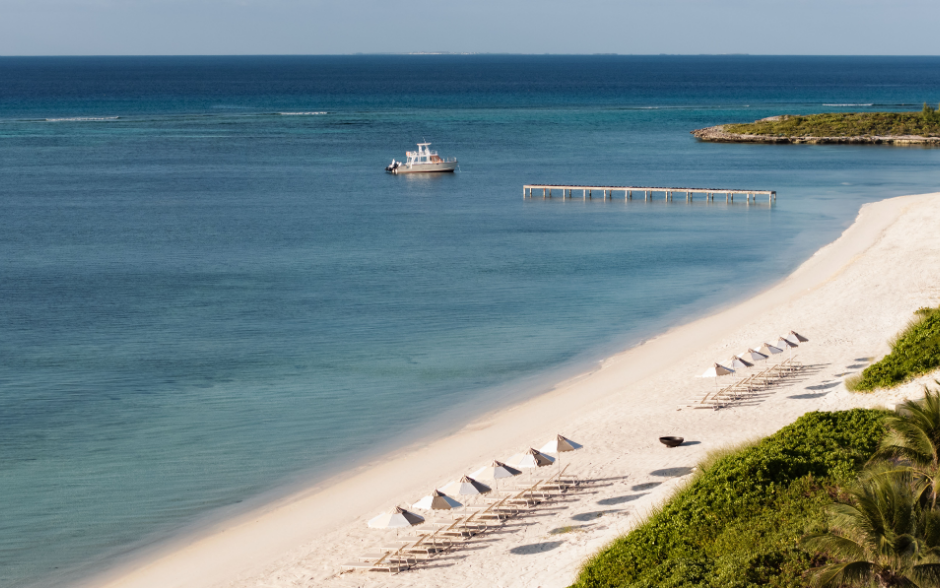 a beach with a boat and a dock