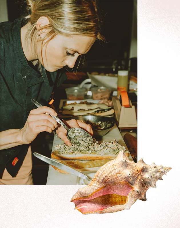 a woman putting food on a piece of bread