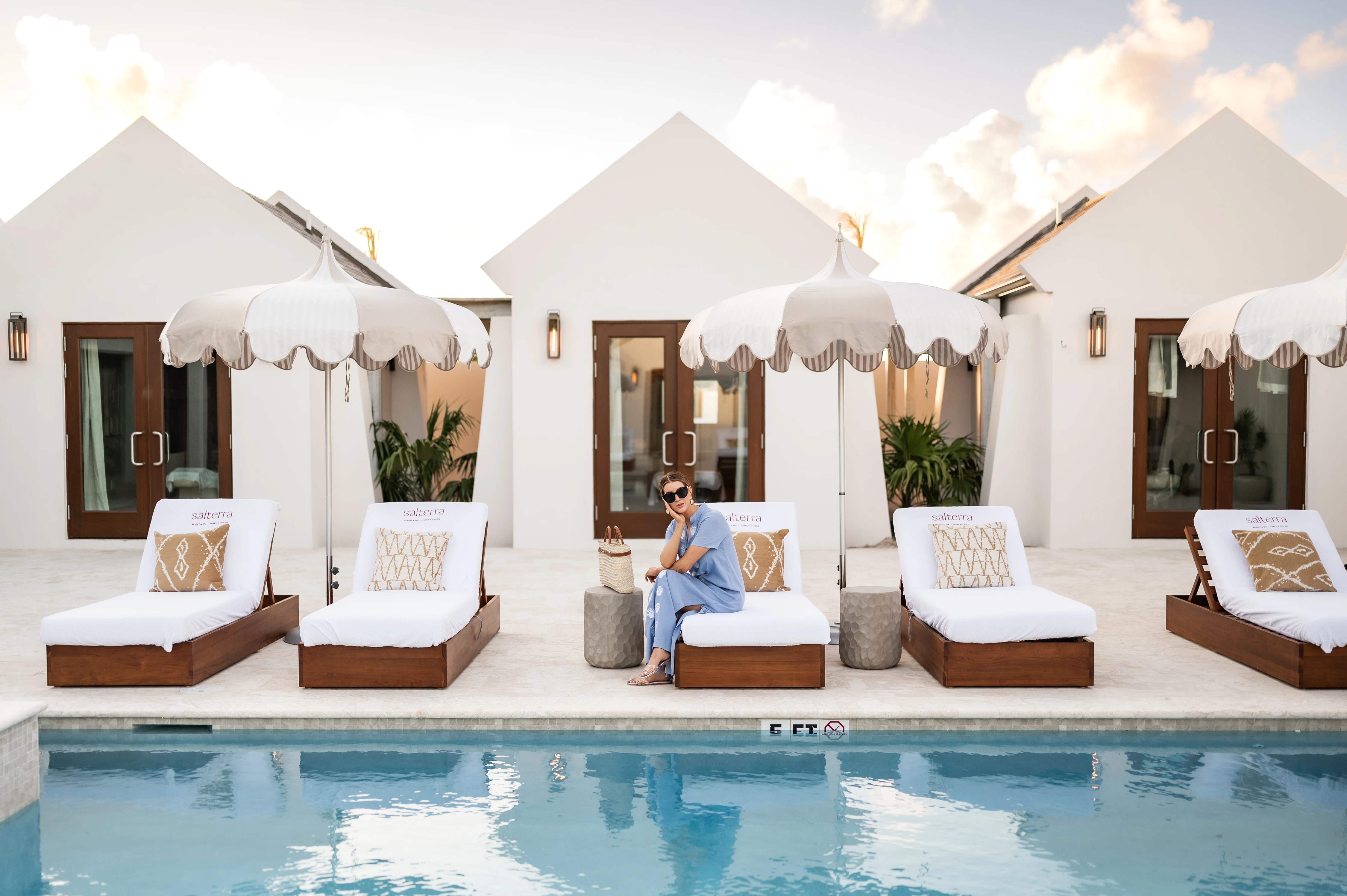 a woman sitting on a pool bed