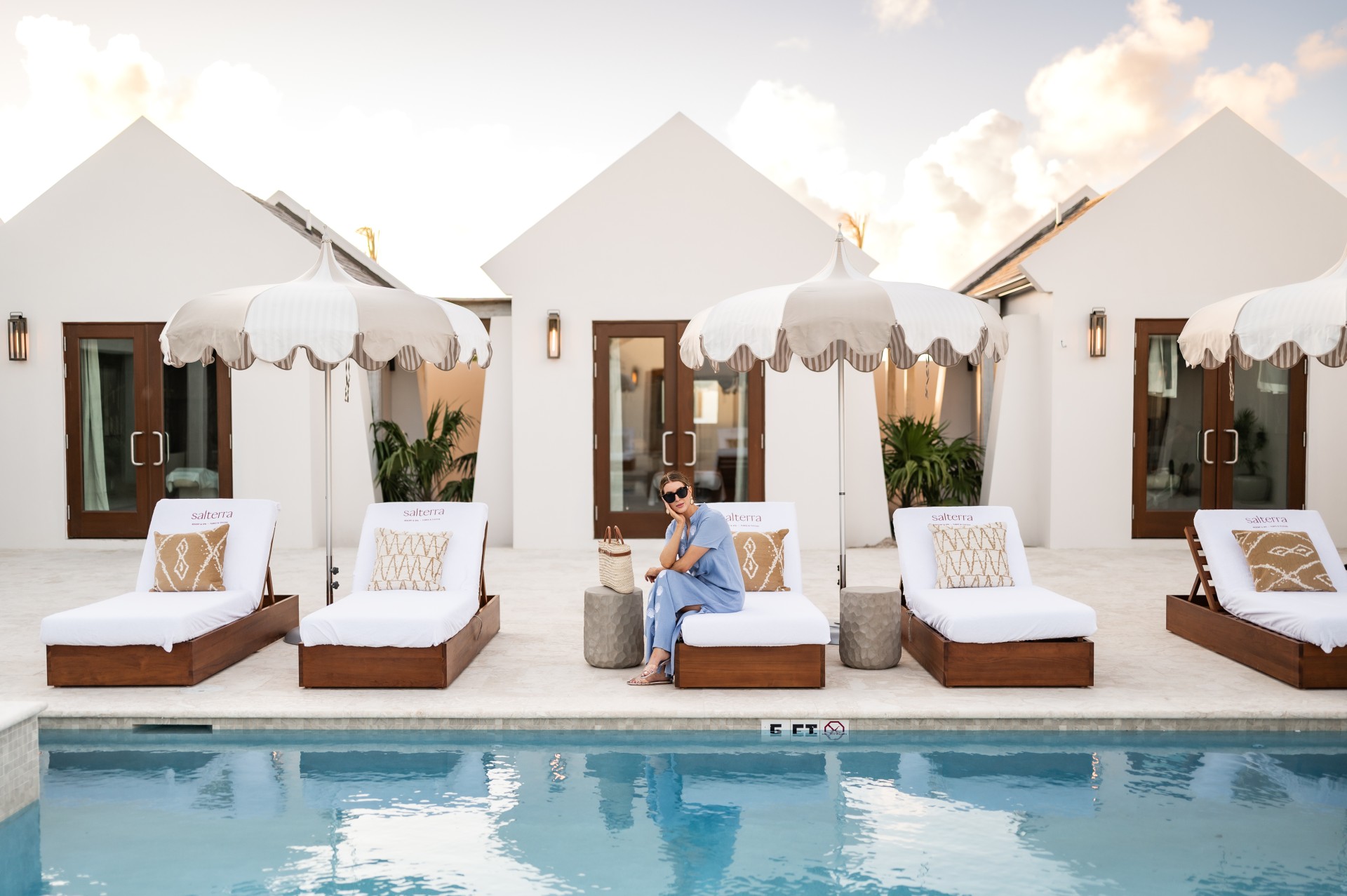 a woman sitting on a pool bed