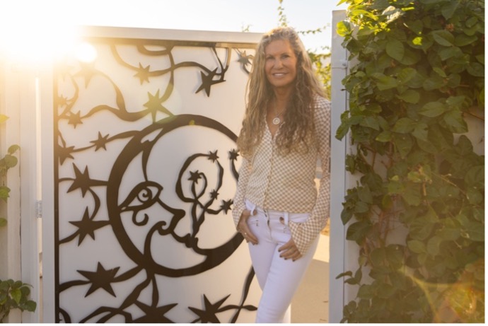 a woman standing next to a wall