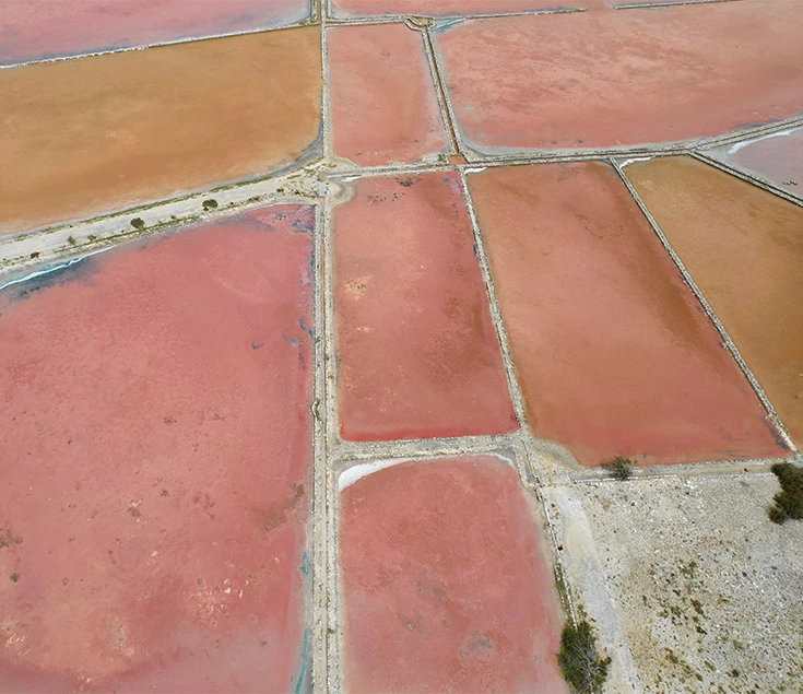 a aerial view of a large area with red and brown land