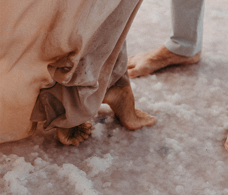 a person's feet and a sheet