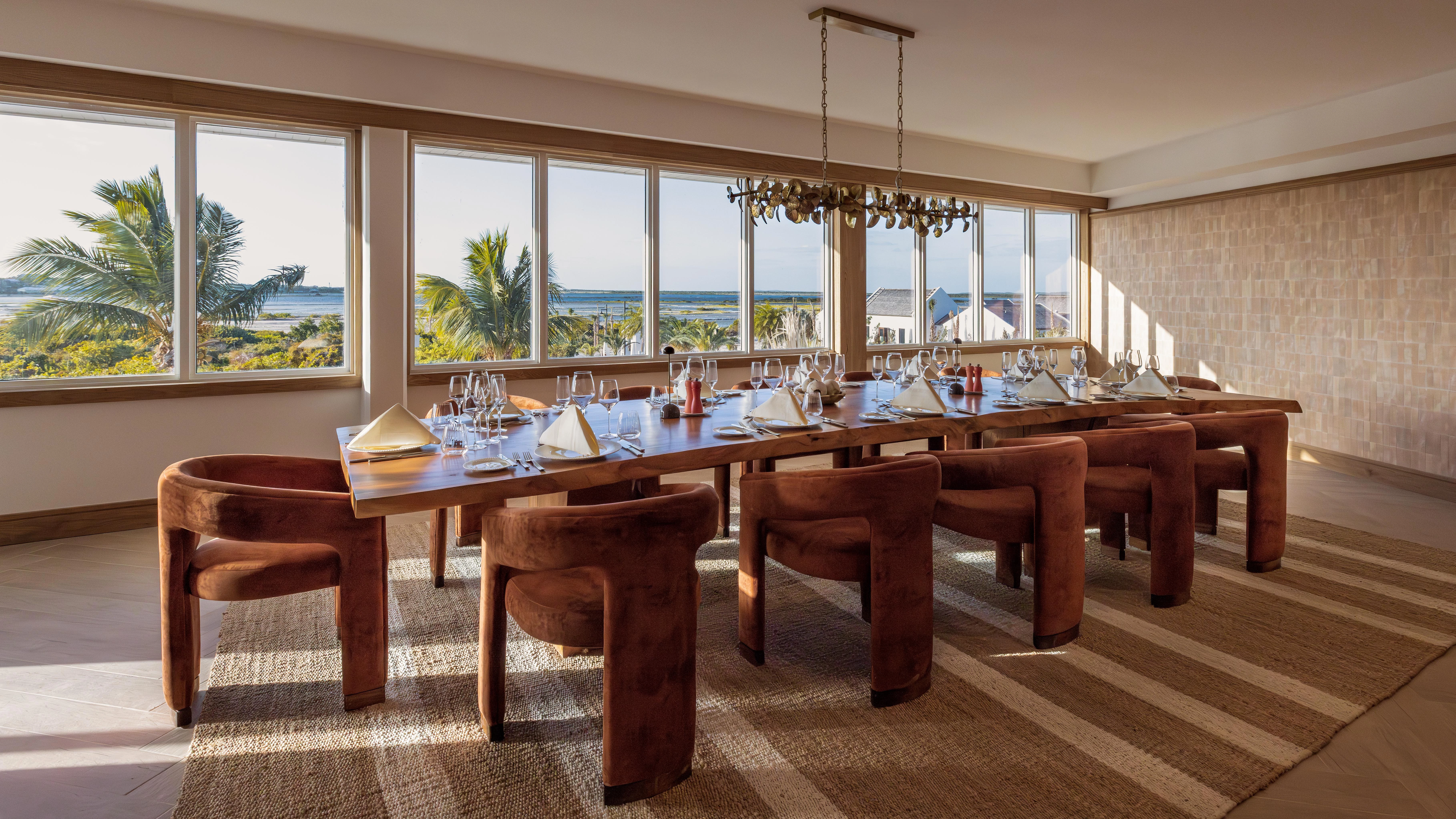 a large table with chairs and glasses
