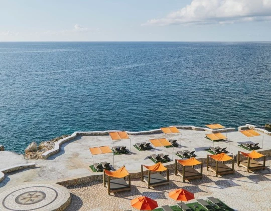 a group of chairs and umbrellas on a beach