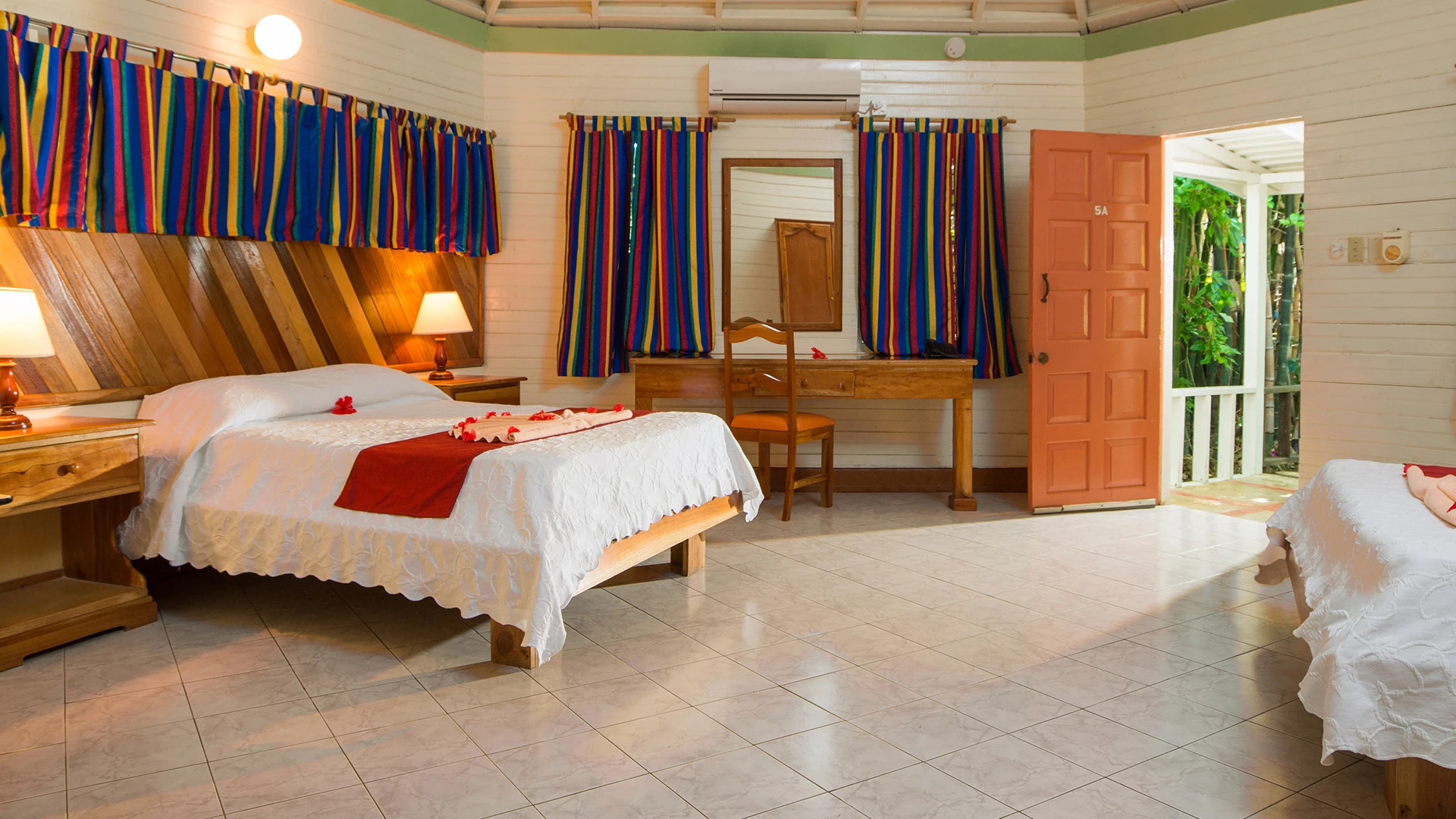 a room with a bed and a mirror