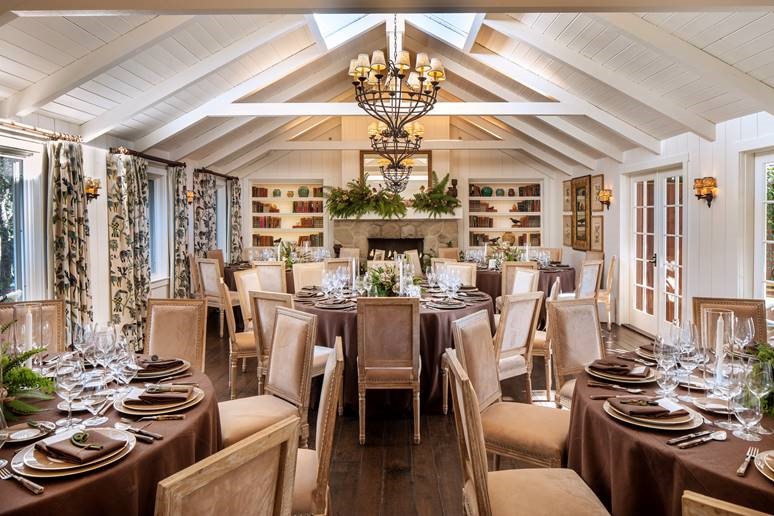 a dining room with a chandelier and chairs