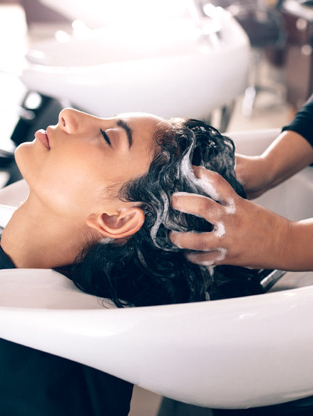 woman getting her hair shampooed