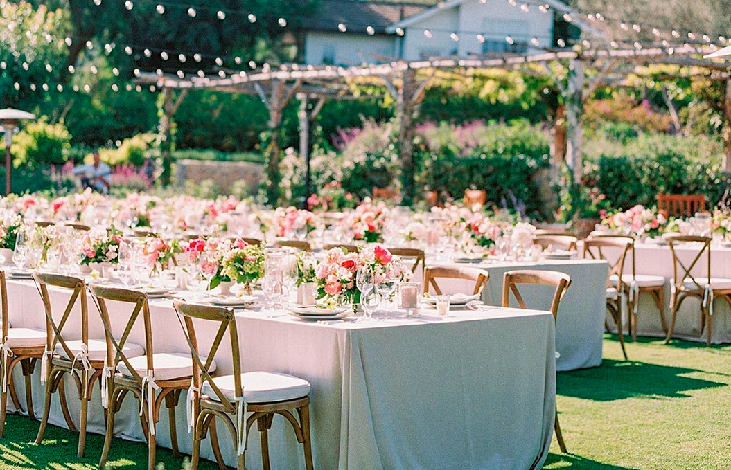 a table with white tables and chairs