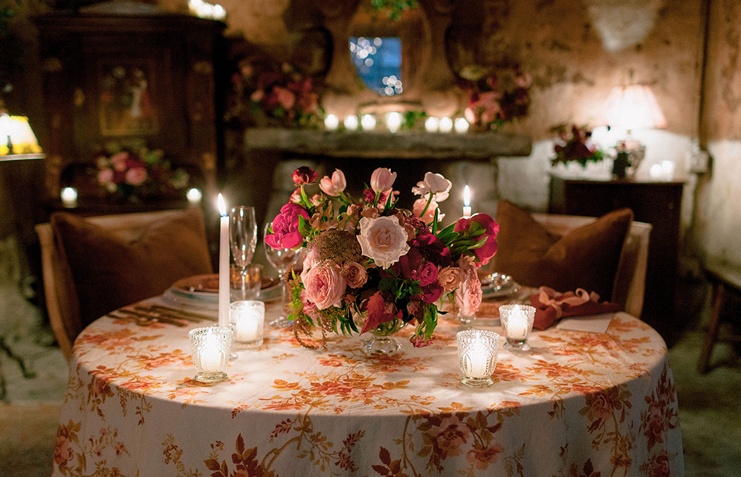 a table with flowers and candles