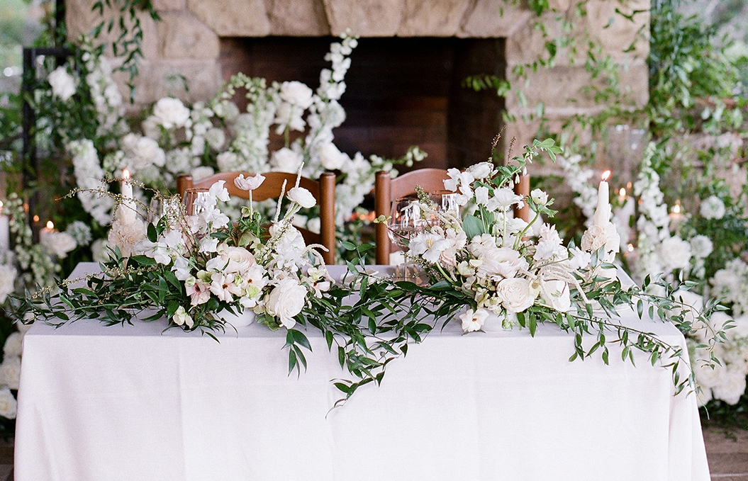 a table with chairs and flowers