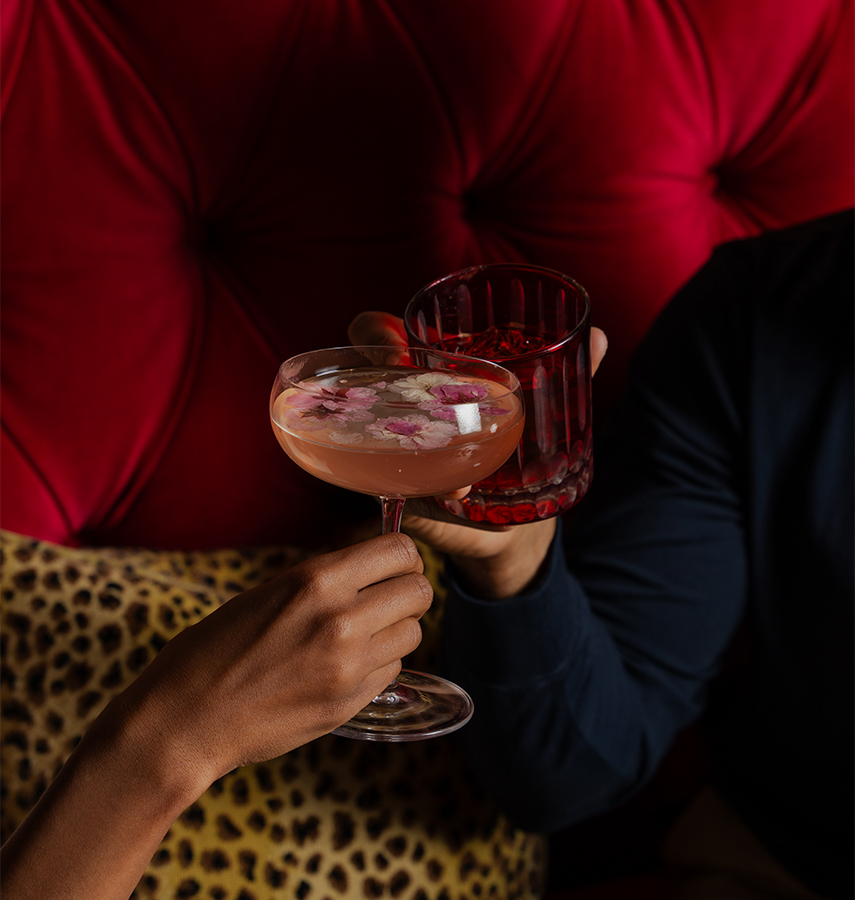 a couple of hands holding drinks