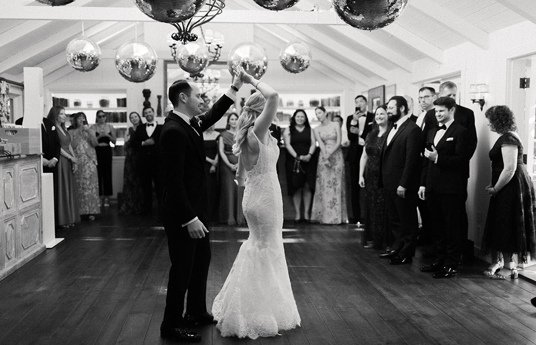 a man and woman dancing in a room full of people