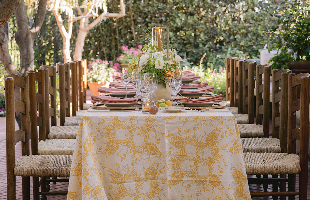 a table with a white tablecloth and flowers on it