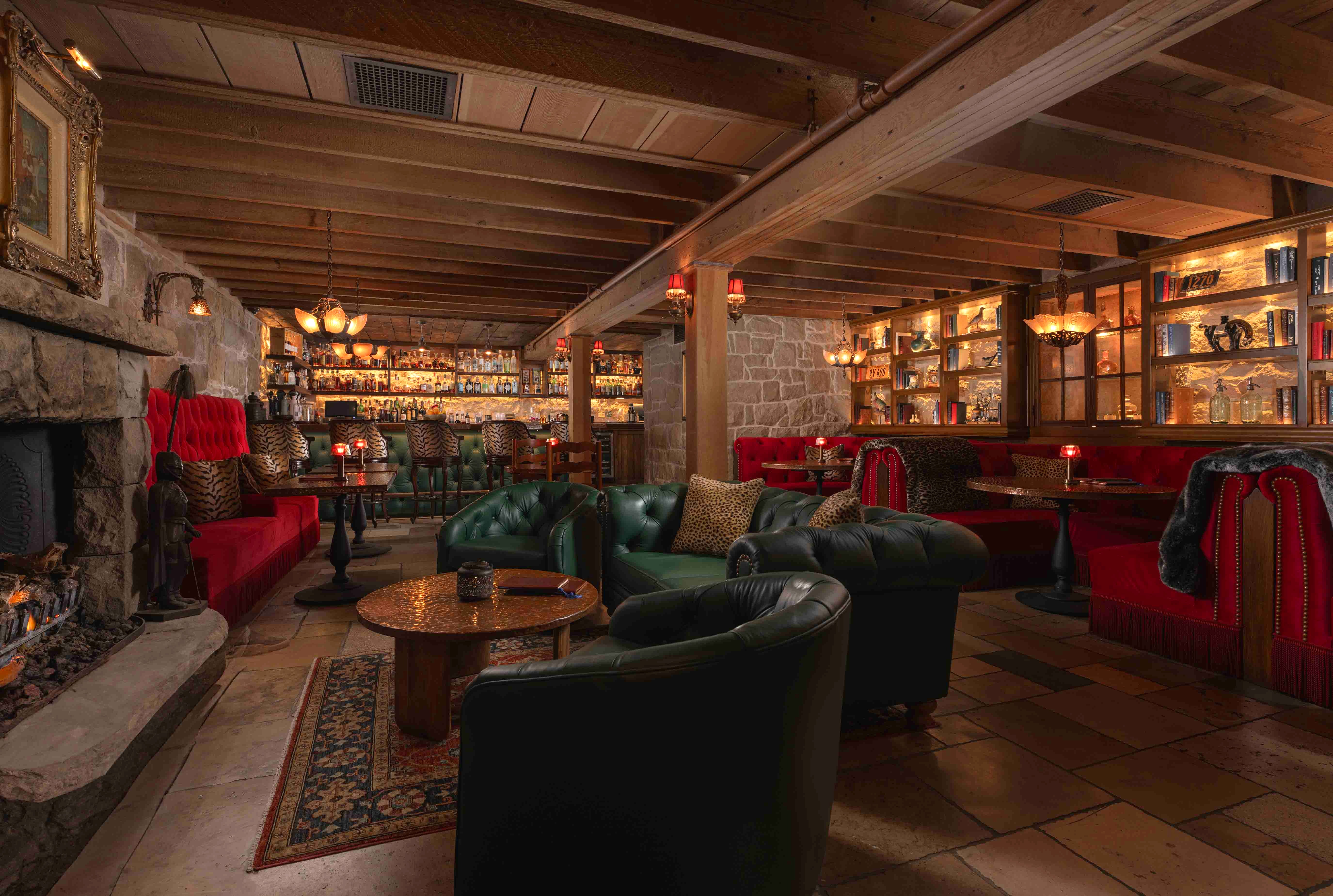 a room with a bar and a bar with a couch and tables