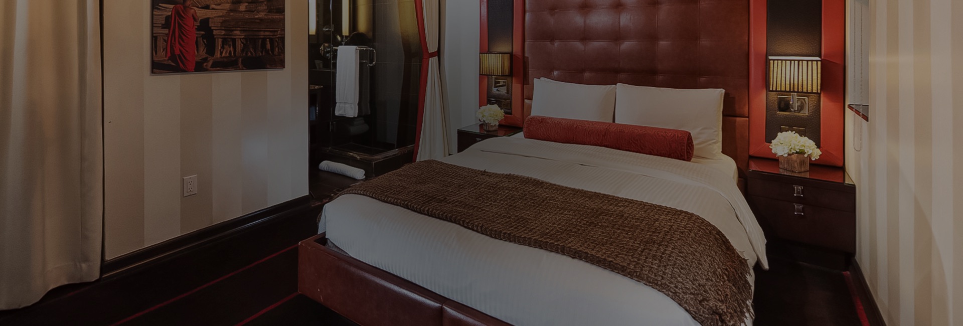 a bed with a brown blanket and a mirror