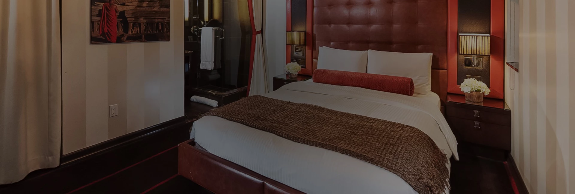 a bed with a brown blanket and a mirror