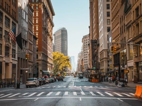 a street with cars and buildings in the background