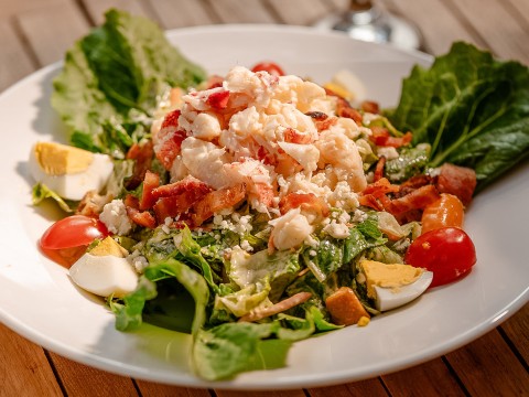 a plate of salad with crab meat and eggs