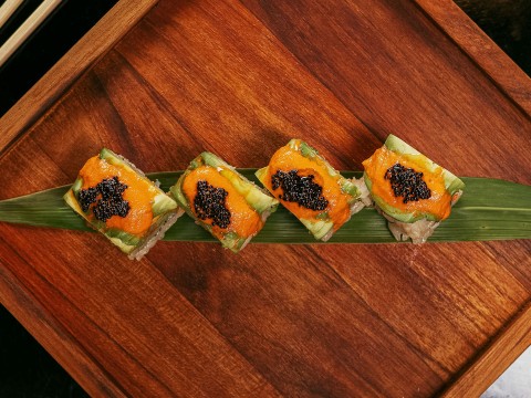 a row of sushi on a leaf