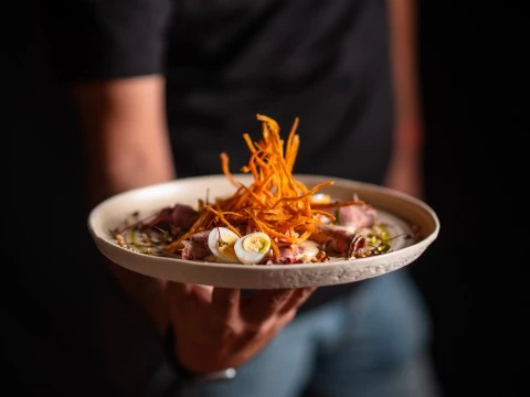 a person holding a plate of food