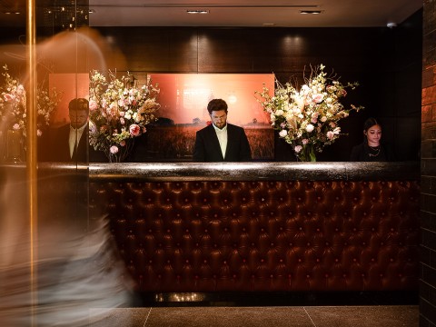 a man standing at a reception desk