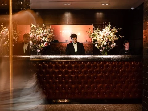 a man standing at a reception desk