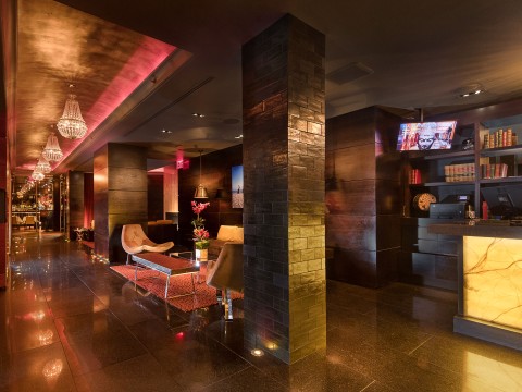 a room with a large brick column and a table