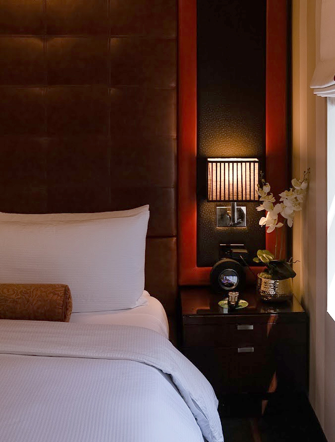 a bed with a lamp and a table