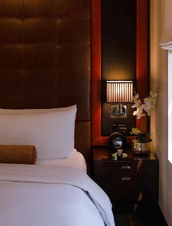 a bed with a lamp and a table