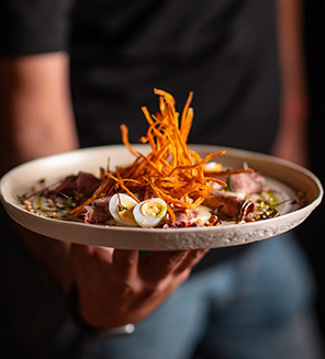 a person holding a plate of food