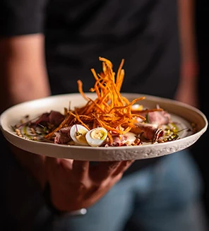 a person holding a plate of food