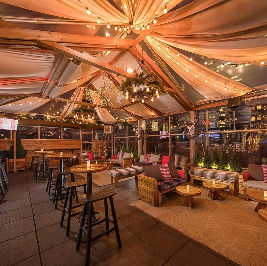 a room with a large tent and tables and chairs