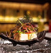 a piece of food with vegetables on top