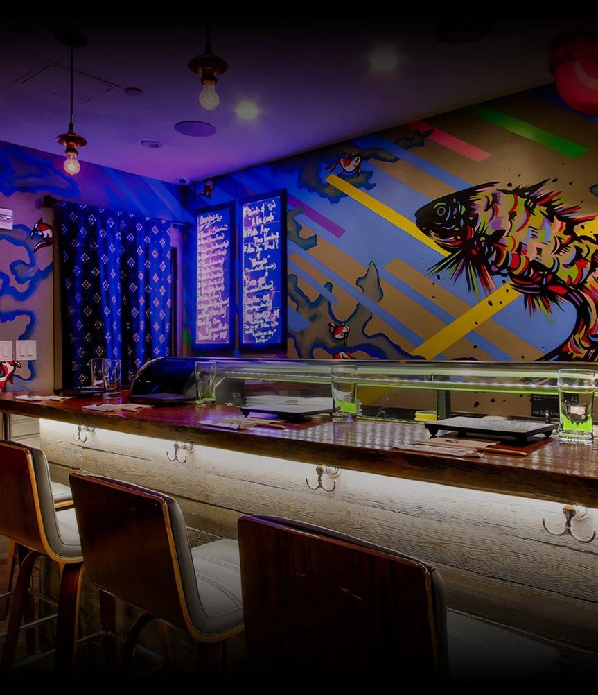 a bar with a fish mural on the wall