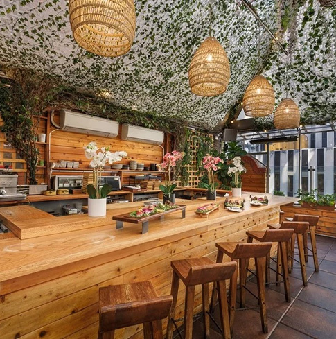 a restaurant with a long counter and chairs