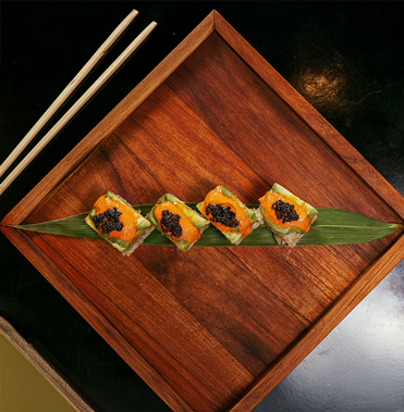 a plate of sushi on a leaf