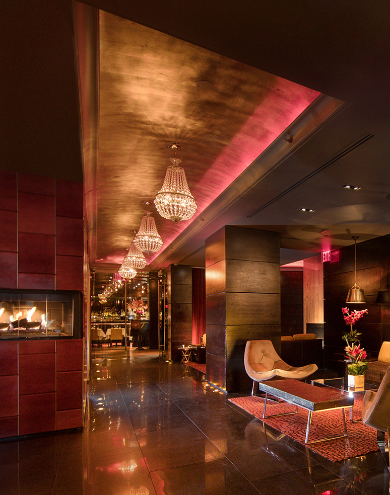 a room with a fireplace and chandeliers